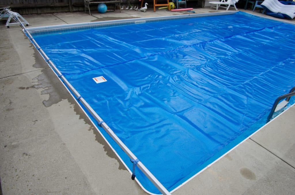 Solar pool cover on swimming pool